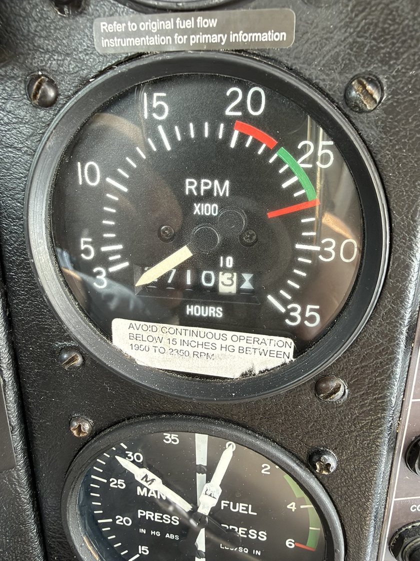 A tachometer photographed with a phone. The hour counter reads 5710.3, with the needle lying across the leading digit.
